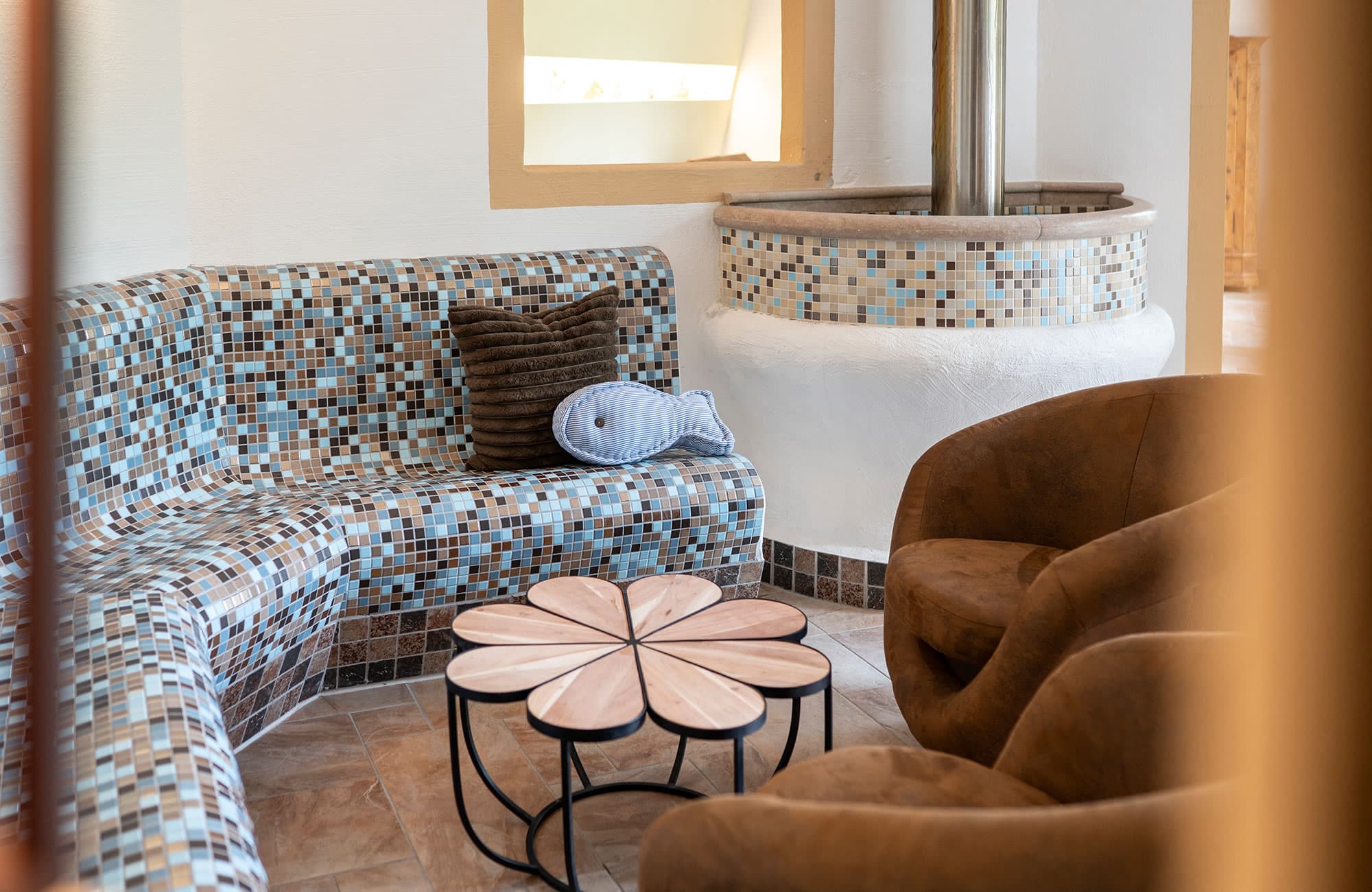 Cozy wellness area with sauna, relaxation area, and heated benches